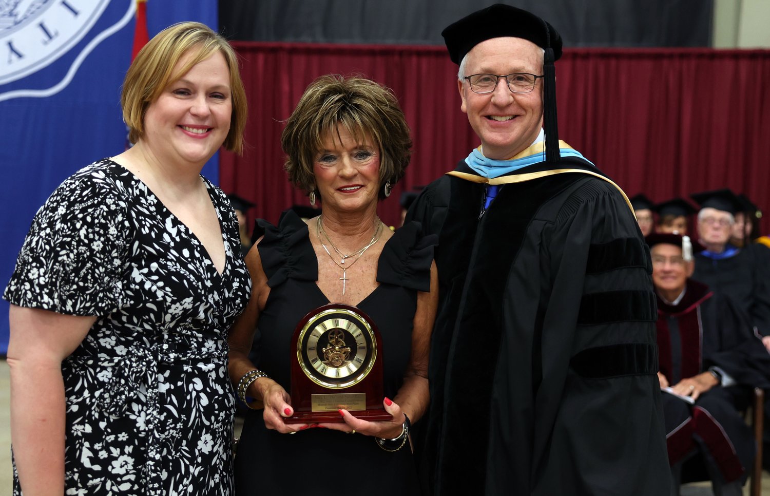 WEST PLAINS RESIDENT Sunie Pace, center, received the Granvil Vaughan Founder’s Award for 2022 on behalf of herself and her late husband, Terry L. “Bo” Pace, during Saturday’s Missouri State University-West Plains (MSU-WP) commencement ceremony at the West Plains Civic Center. With her are her daughter Suzannah, left, and MSU-WP Chancellor Dennis Lancaster, who presented the award.